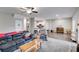 Spacious living room with hardwood floors, plush carpet and ceiling fan leading into a modern kitchen at 209 Shelton Cir, Temple, GA 30179