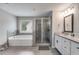 Luxurious bathroom featuring tile floors, a soaking tub, glass enclosed shower, and double vanity at 209 Shelton Cir, Temple, GA 30179