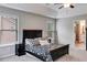 Inviting main bedroom with tray ceilings, carpet floors, natural light, and ensuite bathroom at 209 Shelton Cir, Temple, GA 30179