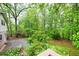 A wooded backyard with a house and a patio at 2288 Hudson Sw Dr, Lilburn, GA 30047