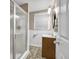 Bathroom with a shower featuring clear glass doors, patterned floors, and small vanity at 2288 Hudson Sw Dr, Lilburn, GA 30047