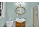 Cozy bathroom with a classic vanity, oval mirror, and a convenient shower stall at 2288 Hudson Sw Dr, Lilburn, GA 30047