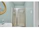 Bathroom with a shower featuring clear glass doors and light blue colored walls at 2288 Hudson Sw Dr, Lilburn, GA 30047