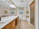 Large bathroom with long vanity, tile floors, and tiled shower at 2288 Hudson Sw Dr, Lilburn, GA 30047