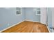 Inviting bedroom featuring gleaming hardwood floors, light blue walls, and ample natural light at 2288 Hudson Sw Dr, Lilburn, GA 30047