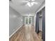 Bedroom with grey walls, light-colored floors, ceiling fans, and double doors to outside at 2288 Hudson Sw Dr, Lilburn, GA 30047