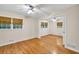 Bright bedroom featuring hardwood floors, neutral walls, and natural light from two windows at 2288 Hudson Sw Dr, Lilburn, GA 30047