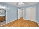 Comfortable bedroom boasts hardwood floors, a ceiling fan, and an ensuite bathroom at 2288 Hudson Sw Dr, Lilburn, GA 30047
