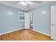 Serene bedroom with hardwood floors, soft blue walls, and an attached bathroom at 2288 Hudson Sw Dr, Lilburn, GA 30047