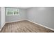 Bedroom with grey walls, light-colored floors, white trim, and a window with greenery outside at 2288 Hudson Sw Dr, Lilburn, GA 30047