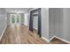 Bedroom with grey walls, light-colored floors, closet with curtain, and double doors to outside at 2288 Hudson Sw Dr, Lilburn, GA 30047