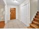 Welcoming foyer with a wooden front door, tiled floor, and convenient closet at 2288 Hudson Sw Dr, Lilburn, GA 30047