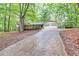 Traditional home showcasing a long driveway, attached garage, and well-maintained lawn at 2288 Hudson Sw Dr, Lilburn, GA 30047