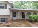 Inviting covered front porch featuring brick arches, providing shade and character to the entrance of this charming property at 2288 Hudson Sw Dr, Lilburn, GA 30047
