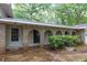 Inviting covered front porch featuring brick arches, providing shade and character to the entrance of this charming property at 2288 Hudson Sw Dr, Lilburn, GA 30047