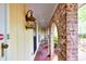 The covered entryway showcases unique brick archways and elegant lighting, enhancing the curb appeal of this inviting home at 2288 Hudson Sw Dr, Lilburn, GA 30047