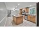 Well-lit kitchen featuring stainless steel appliances, a central island, and tile flooring at 2288 Hudson Sw Dr, Lilburn, GA 30047