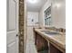 Functional laundry room features utility sink and brick accent wall at 2288 Hudson Sw Dr, Lilburn, GA 30047