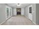 Open living area with stone fireplace, built-in shelves and doors leading to the outside at 2288 Hudson Sw Dr, Lilburn, GA 30047