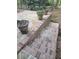 Cozy patio space featuring a unique brick step and flagstone, surrounded by lush greenery at 2288 Hudson Sw Dr, Lilburn, GA 30047