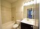 Bathroom featuring a vanity with dark cabinets, tiled floors, and a shower-tub combo at 2514 Norwood Park Crossing, Doraville, GA 30340