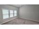 Bedroom with three large windows, ceiling fan and neutral carpet at 2514 Norwood Park Crossing, Doraville, GA 30340