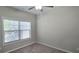 Cozy bedroom features neutral carpeting, ceiling fan, and a bright window at 2514 Norwood Park Crossing, Doraville, GA 30340