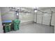 Spacious garage with storage racks, epoxy floor, and overhead door at 2514 Norwood Park Crossing, Doraville, GA 30340