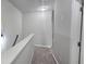 Upstairs hallway has neutral paint, carpeted floor, and a light fixture at 2514 Norwood Park Crossing, Doraville, GA 30340