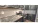 Kitchen with granite countertops, stainless steel appliances and gray subway tile backsplash at 2514 Norwood Park Crossing, Doraville, GA 30340