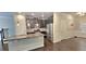 View of an open kitchen with a granite island, stainless appliances, and dark wood cabinets at 2514 Norwood Park Crossing, Doraville, GA 30340