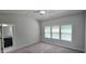 Main bedroom with en-suite bathroom access, three large windows and ceiling fan at 2514 Norwood Park Crossing, Doraville, GA 30340