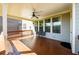 Enjoy the covered back porch with ceiling fan and wood floors at 4041 Woodward Walk Ln, Suwanee, GA 30024