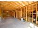 Unfinished basement with exposed wood beams and concrete floors, offering potential for customization at 4041 Woodward Walk Ln, Suwanee, GA 30024
