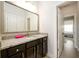 Bathroom featuring granite countertops, dark cabinets, and a large mirror with great lighting at 4041 Woodward Walk Ln, Suwanee, GA 30024