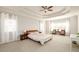 Spacious bedroom with a tray ceiling, neutral carpet, and generous natural light at 4041 Woodward Walk Ln, Suwanee, GA 30024