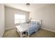Cozy bedroom featuring a white bed with patterned quilt and a bright window with natural light at 4041 Woodward Walk Ln, Suwanee, GA 30024
