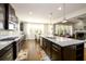 Open-concept kitchen with a large island and a seamless transition to the dining and living areas at 4041 Woodward Walk Ln, Suwanee, GA 30024