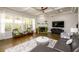 Bright living room with large windows, fireplace, hardwood floors, and comfortable seating at 4041 Woodward Walk Ln, Suwanee, GA 30024