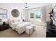 Bright bedroom features neutral tones, plush carpet, a work space, and a large window overlooking the backyard at 5515 Misty Glen Ln, Cumming, GA 30040
