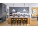 Modern kitchen with gray cabinetry, stainless steel appliances and a large center island at 5515 Misty Glen Ln, Cumming, GA 30040