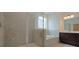 Luxurious bathroom with a glass shower, soaking tub, and dark wood vanity at 2962 Girard Ln, Duluth, GA 30097
