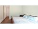 Cozy bedroom with a wood frame bed and soft blue pillows near a doorway at 2962 Girard Ln, Duluth, GA 30097