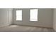 Bright bedroom with neutral walls, plush carpet, and natural light streaming through two windows, creating a cozy and inviting atmosphere at 2962 Girard Ln, Duluth, GA 30097