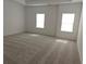 Expansive bedroom featuring plush carpeting and two windows that fill room with natural light at 2962 Girard Ln, Duluth, GA 30097