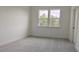 Bright bedroom with plush carpeting, a large window offering picturesque views, and a closet for ample storage at 2962 Girard Ln, Duluth, GA 30097
