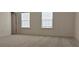 Bright and airy bedroom featuring plush carpeting, natural light from two windows, and neutral walls at 2962 Girard Ln, Duluth, GA 30097