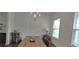Dining room featuring a wooden table, elegant chandelier, and windows offering natural light at 2962 Girard Ln, Duluth, GA 30097