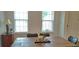 Bright dining area with wooden table, cushioned chairs, and natural light from the large windows at 2962 Girard Ln, Duluth, GA 30097