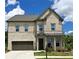 A beautiful two-story brick home with a well-maintained lawn and a two-car garage on a sunny day at 2962 Girard Ln, Duluth, GA 30097